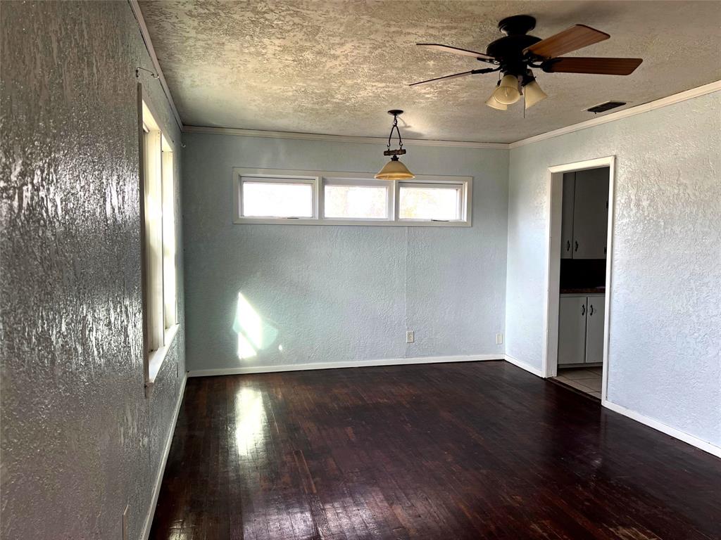 402 South Red River Street Henrietta, TX 76365 - Photo 10 of 20 a view of empty room with wooden floor and fan