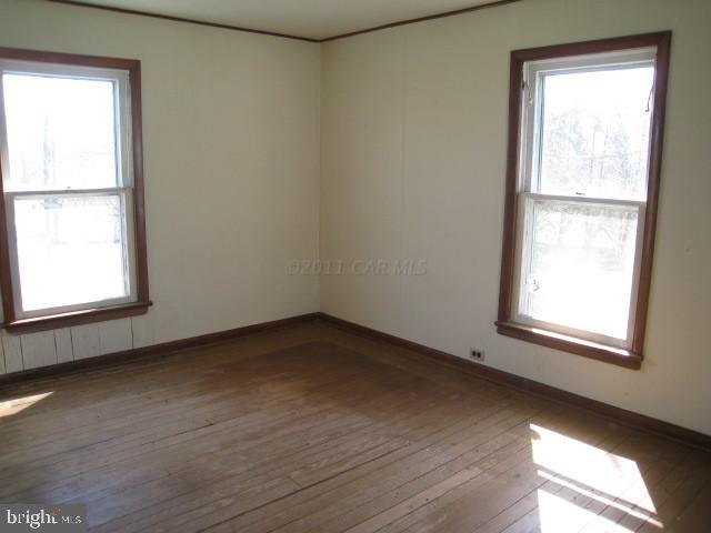 5905 Coventry Parish Road Westover, MD 21871 - Photo 8 of 9 an empty room with wooden floor and windows