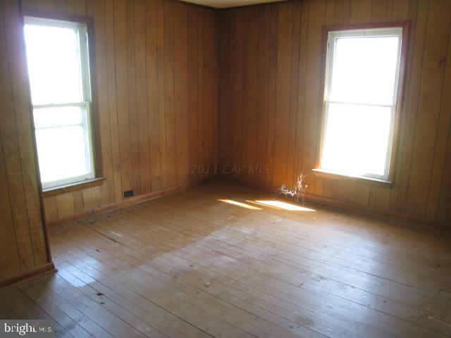 5905 Coventry Parish Road Westover, MD 21871 - Photo 9 of 9 an empty room with wooden floor and windows