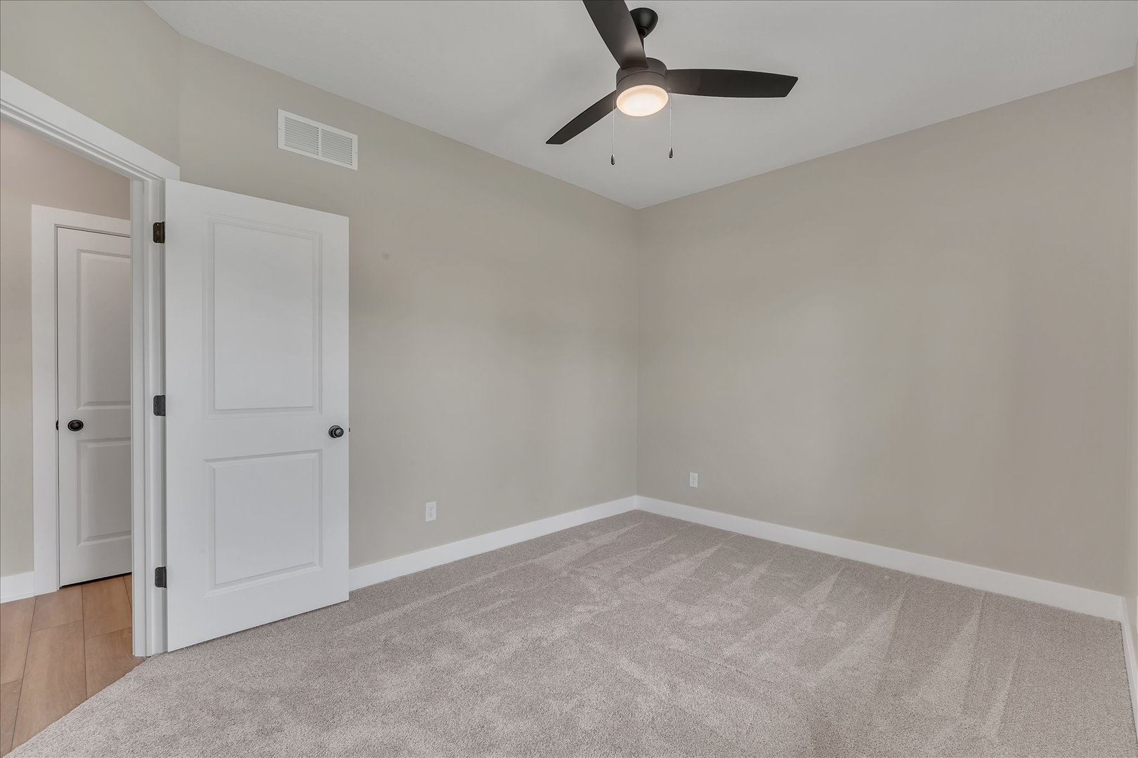 455 Rhonda Road New Liberty, IA 52765 - Photo 48 of 54 an empty room with a ceiling fan and a window