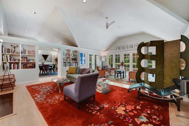 a living room with furniture a rug and a bookshelf