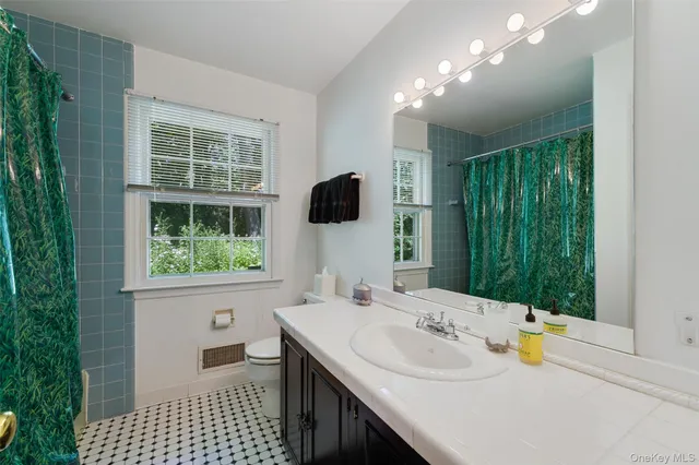 a bathroom with a sink vanity and a mirror