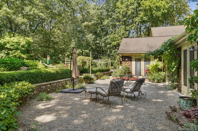 a view of a patio with table and chairs and potted plants