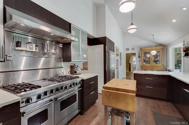 a kitchen with stainless steel appliances granite countertop a stove and a refrigerator