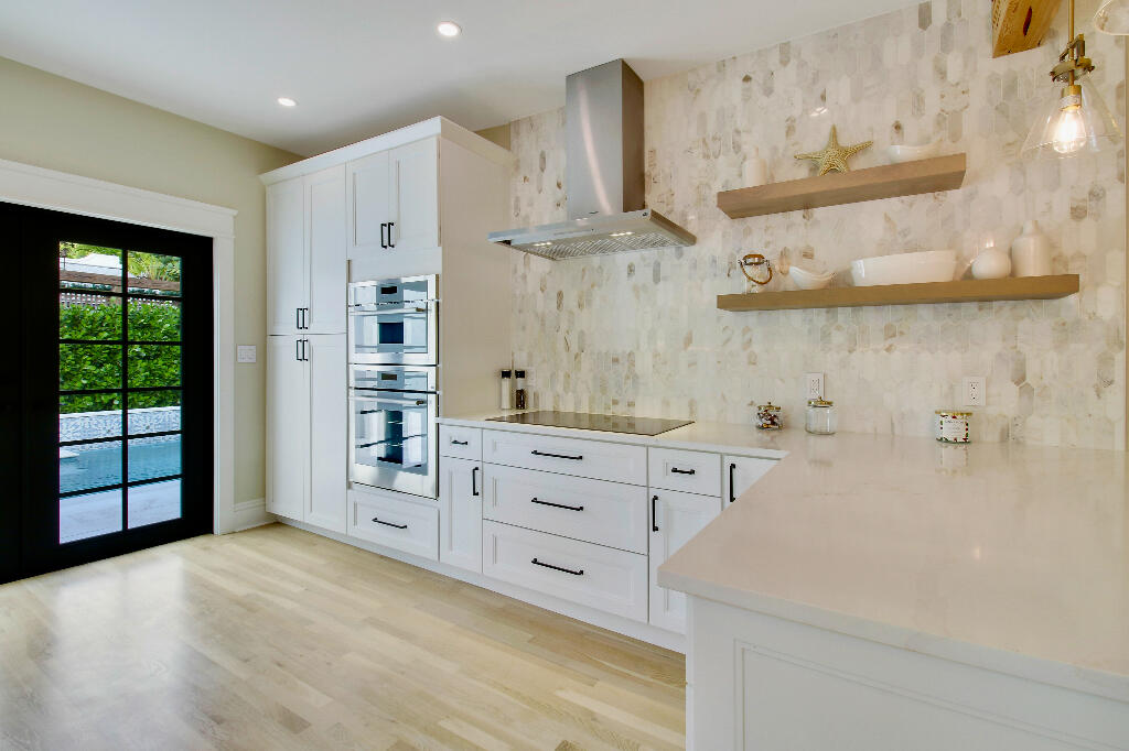 623 Avon Road West Palm Beach, FL 33401 - Photo 12 of 39 a spacious bathroom with a double vanity sink and a mirror