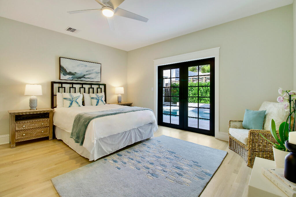 623 Avon Road West Palm Beach, FL 33401 - Photo 20 of 39 a spacious bedroom with a bed a couch and a large window
