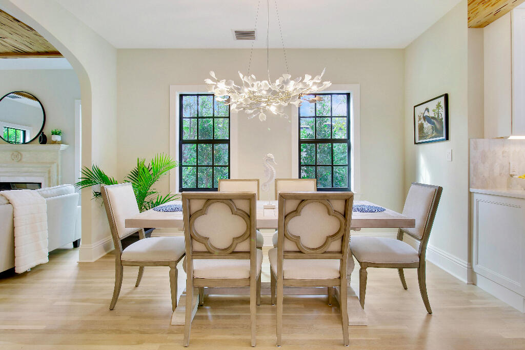 623 Avon Road West Palm Beach, FL 33401 - Photo 7 of 39 a view of a dining room with furniture a chandelier and wooden floor