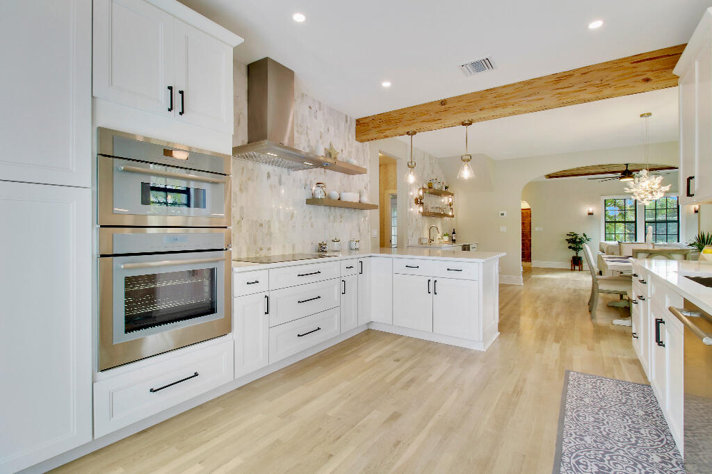 623 Avon Road West Palm Beach, FL 33401 - Photo 10 of 39 a kitchen with stainless steel appliances kitchen island granite countertop a stove and white cabinets