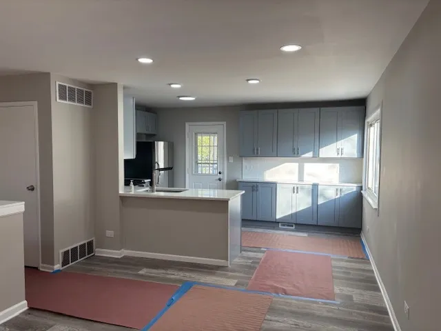 a kitchen with stainless steel appliances a refrigerator stove and microwave