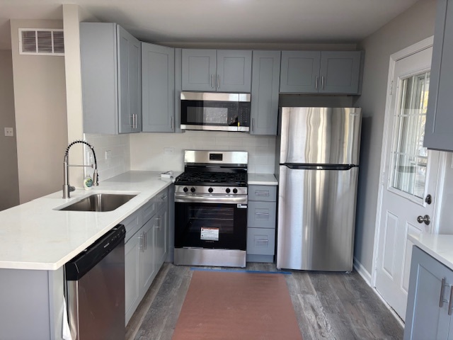 201 East Rose Street Glenwood, IL 60425 - Photo 10 of 49 a kitchen with stainless steel appliances a refrigerator stove and microwave