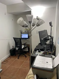 a room with gym equipment and view of living room