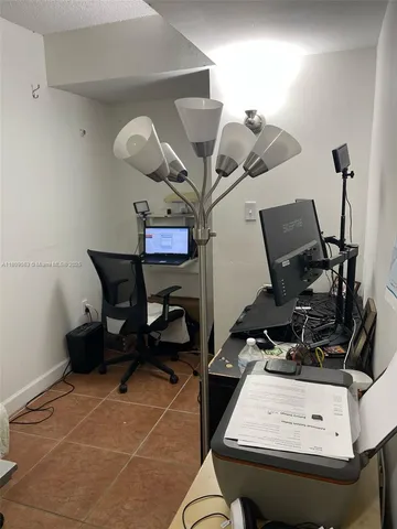 a room with gym equipment and view of living room