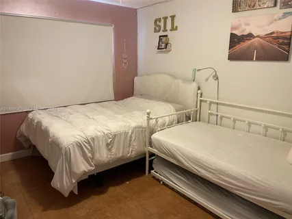 a bedroom with two beds and a couch