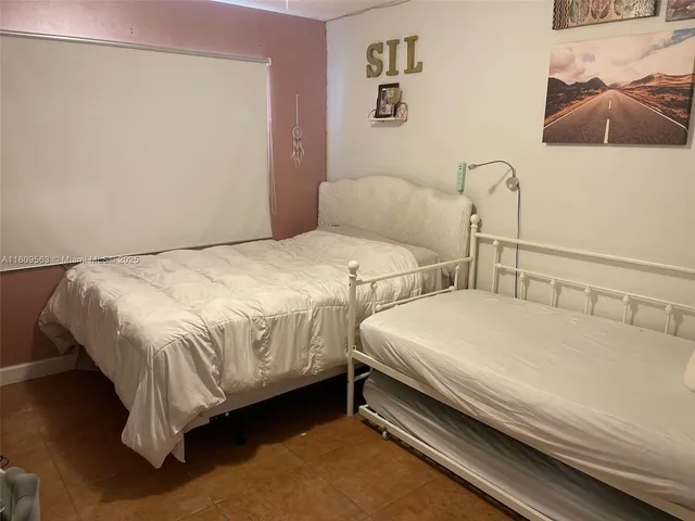 a bedroom with two beds and a couch
