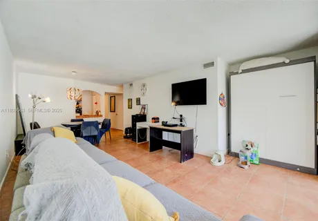 a view of a livingroom with furniture and a flat screen tv