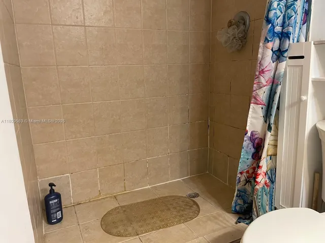 a bathroom with a toilet and shower