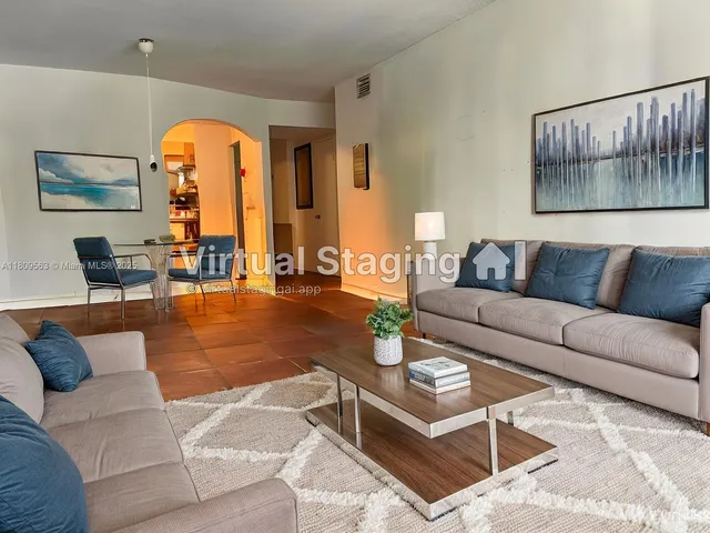 a living room with furniture a wooden floor and a large window