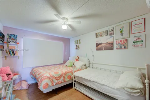 a bedroom with a bed and book shelf