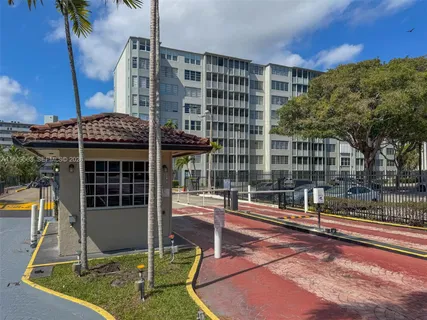 a view of a tall building with a yard
