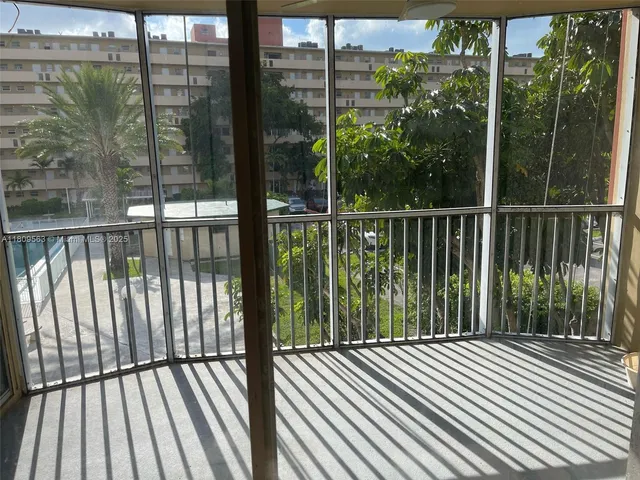 a view of a balcony with floor to ceiling window wooden floor