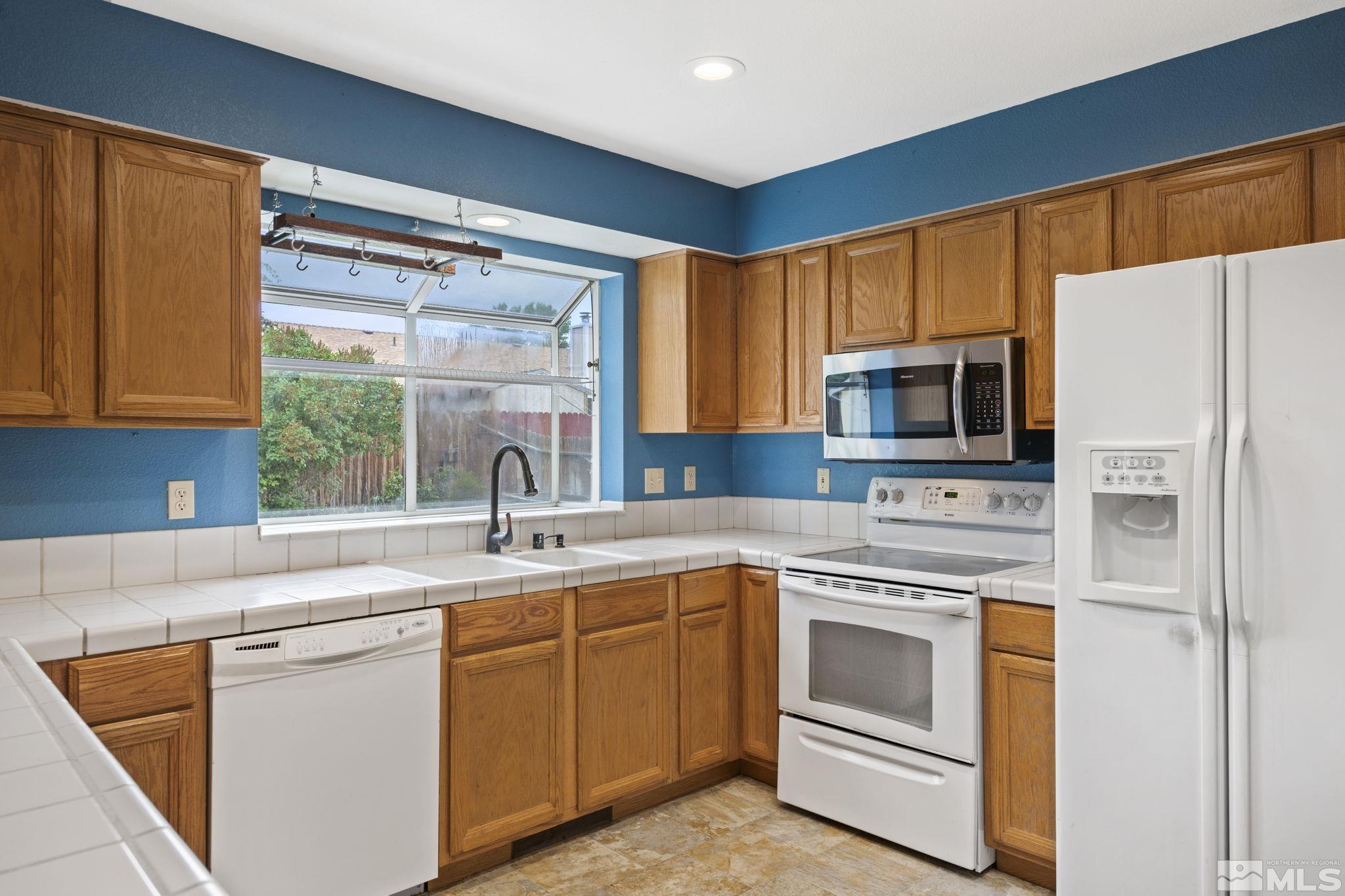 403 Aspen Drive Dayton, NV 89403 - Photo 11 of 36 a kitchen with a sink stove and microwave