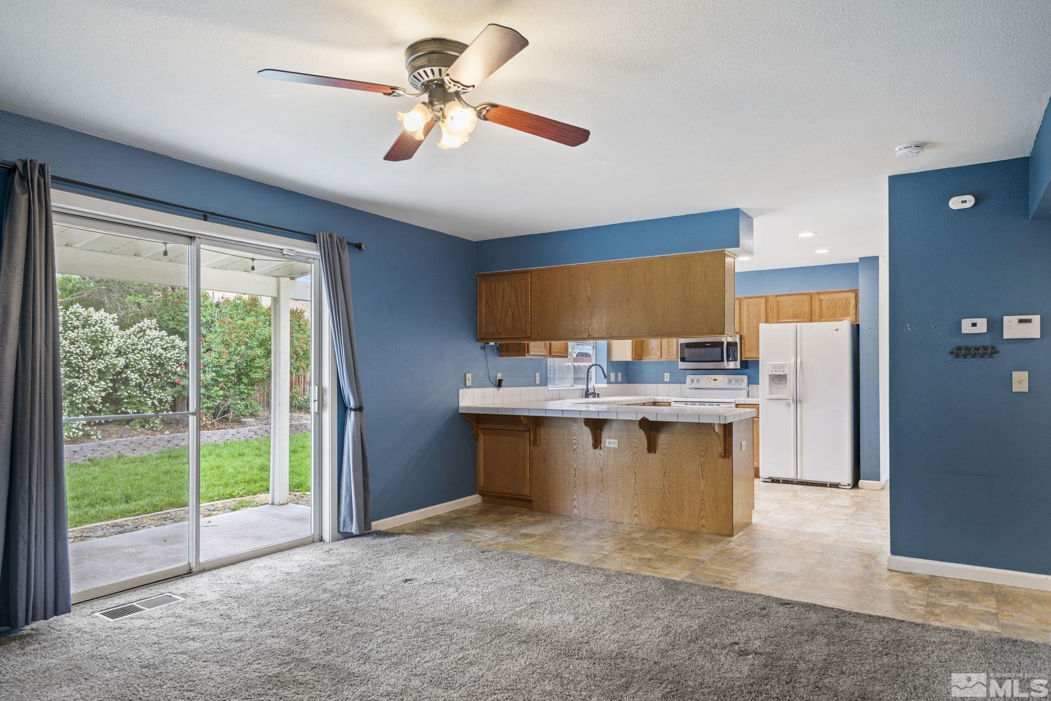 403 Aspen Drive Dayton, NV 89403 - Photo 14 of 36 a view of open kitchen with granite countertop a stove top oven
