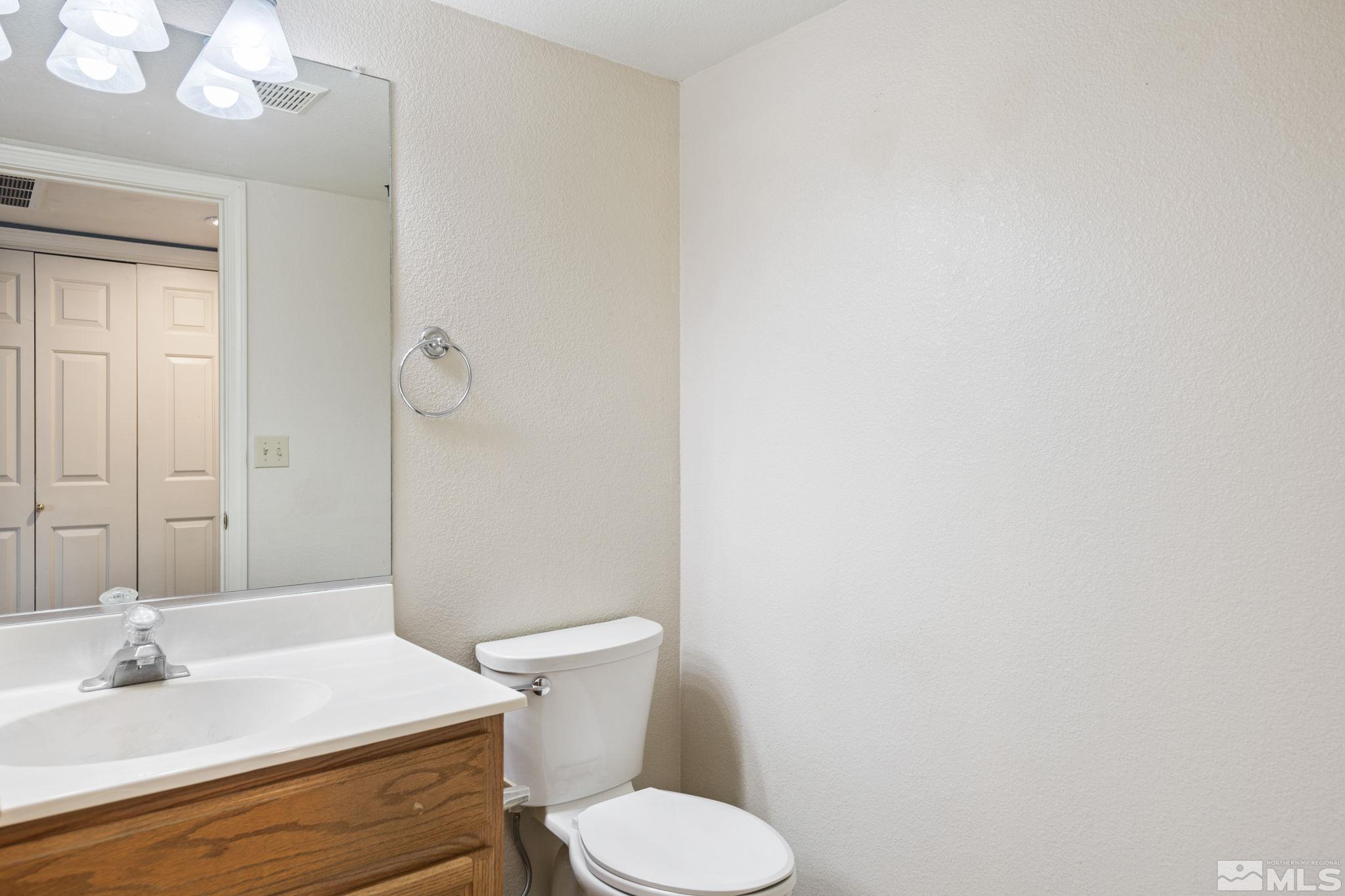 403 Aspen Drive Dayton, NV 89403 - Photo 15 of 36 a bathroom with a sink toilet and mirror
