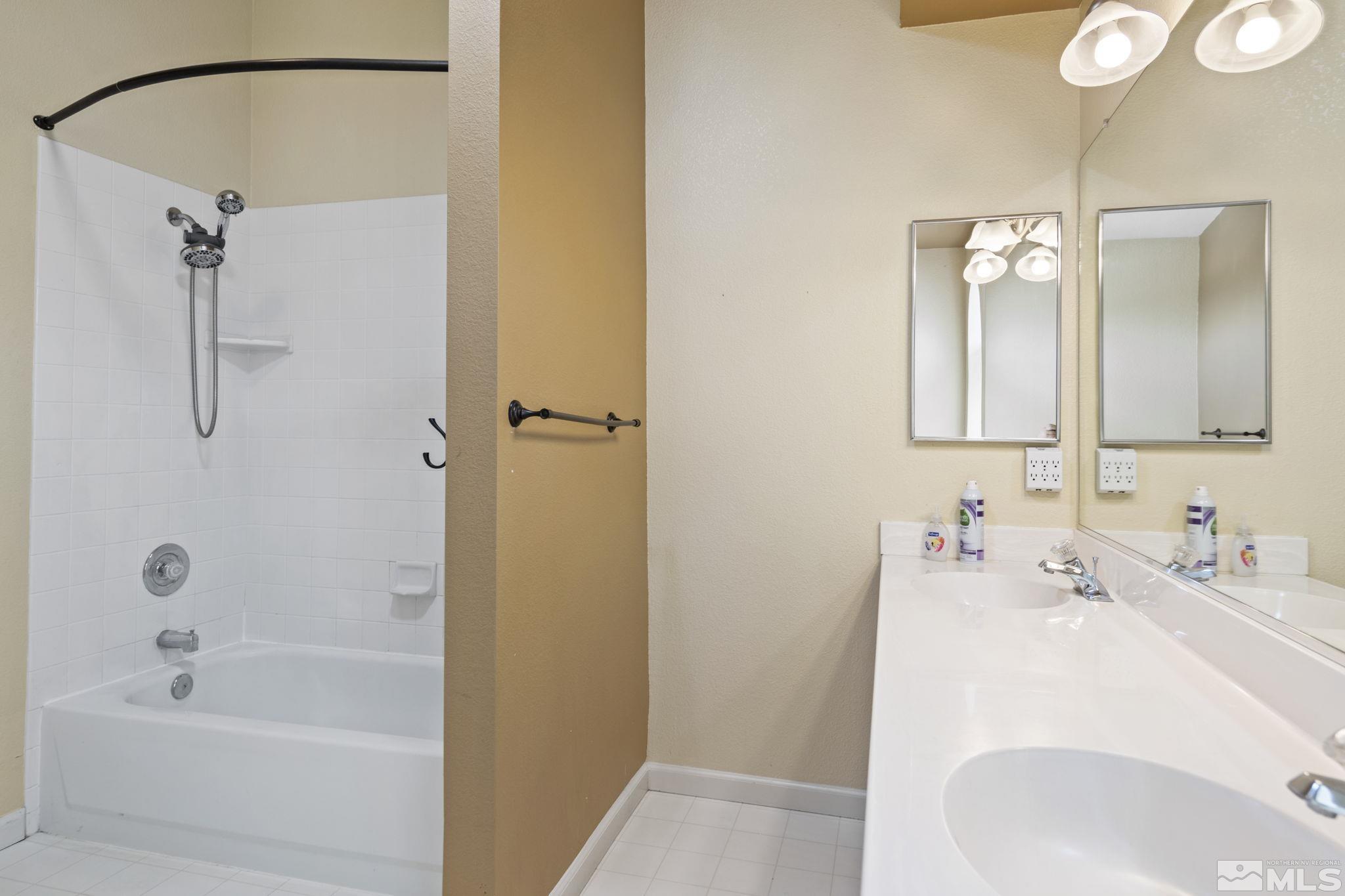 403 Aspen Drive Dayton, NV 89403 - Photo 23 of 36 a bathroom with a tub sink and mirror