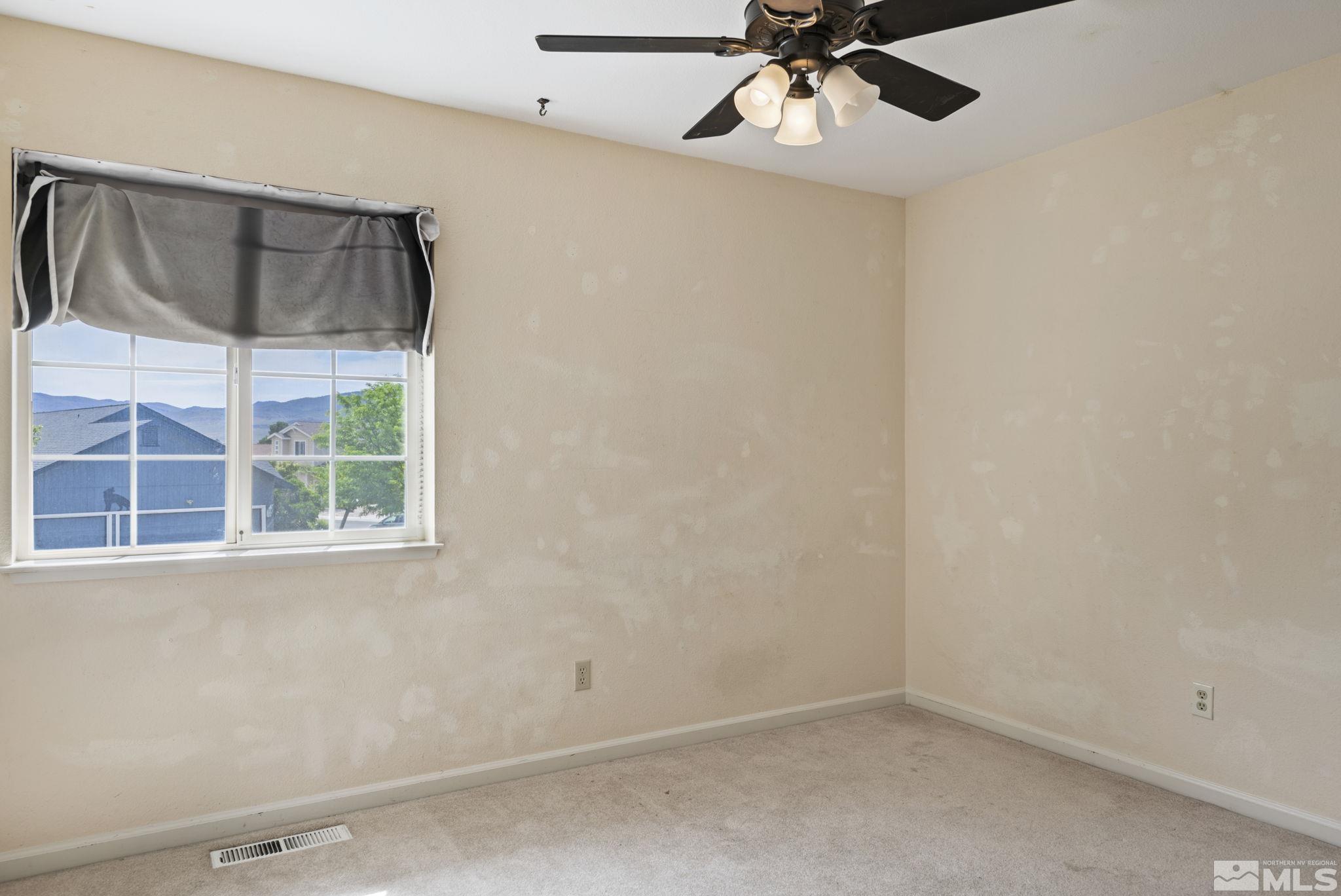 403 Aspen Drive Dayton, NV 89403 - Photo 24 of 36 an empty room with a window and a fan