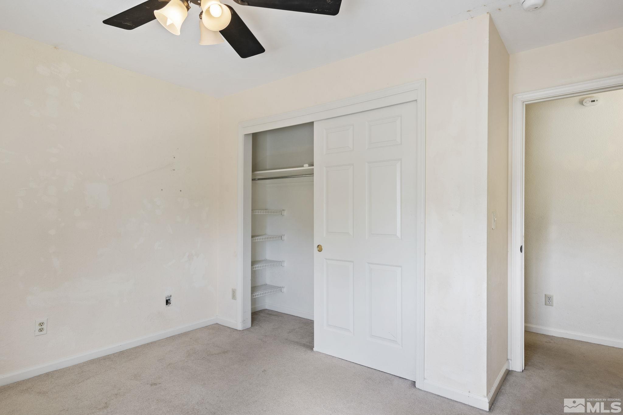 403 Aspen Drive Dayton, NV 89403 - Photo 25 of 36 an empty room with a ceiling fan and carpet