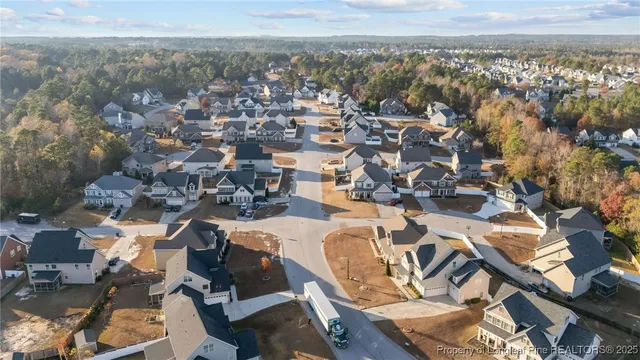 an aerial view of a residential houses with city view