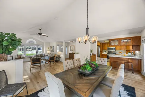 a living room with furniture dining table and a chandelier