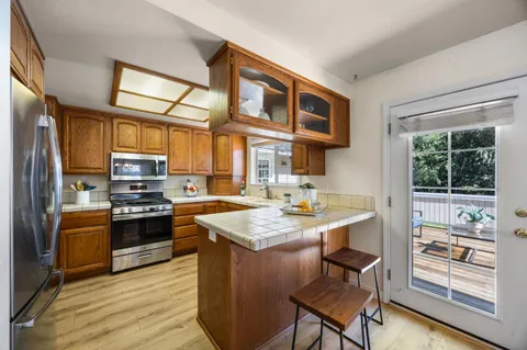 a kitchen with stainless steel appliances granite countertop a stove and a refrigerator