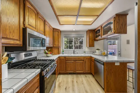a kitchen with stainless steel appliances granite countertop a stove and a sink
