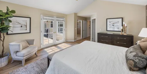 a bedroom with a bed a couch and dresser