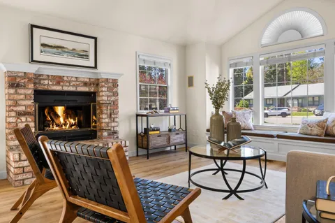 a living room with furniture a table and a fireplace