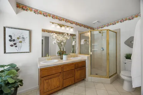 a spacious bathroom with a shower sink and mirror