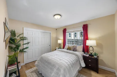 a bedroom with a bed and a potted plant