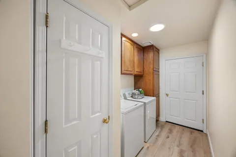 a view of a kitchen with white cabinets