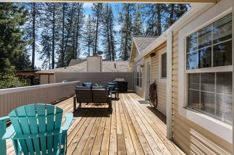 a view of backyard with swimming pool and seating space