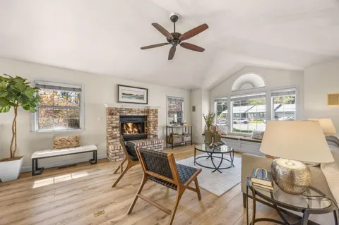 a living room with furniture a fireplace and a table