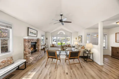 a view of a livingroom with furniture window and wooden floor