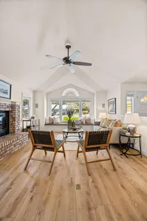 a living room with fireplace furniture and a wooden floor