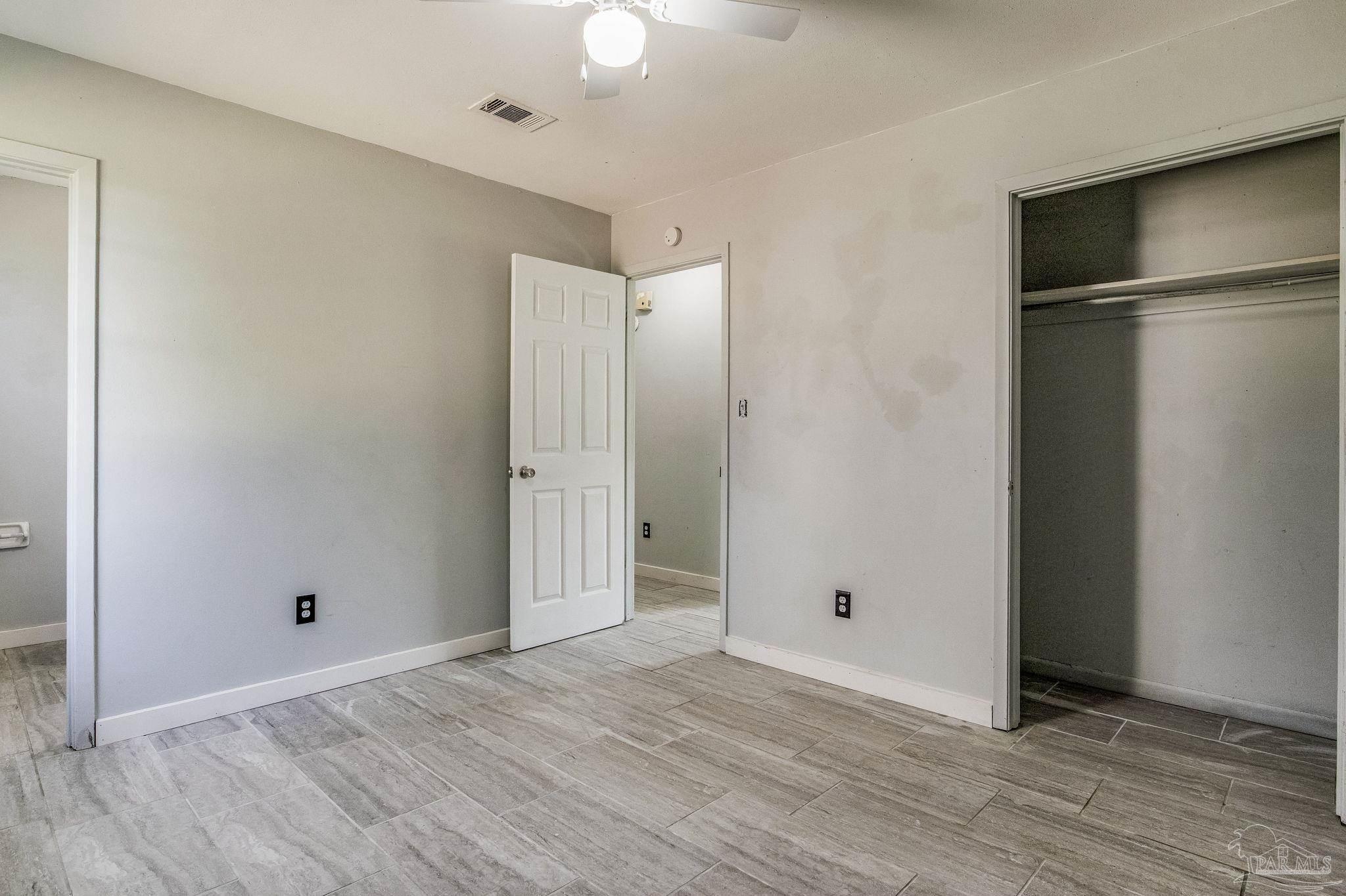 5254 Jenny Circle Pace, FL 32571 - Photo 20 of 44 a view of an empty room with wooden floor
