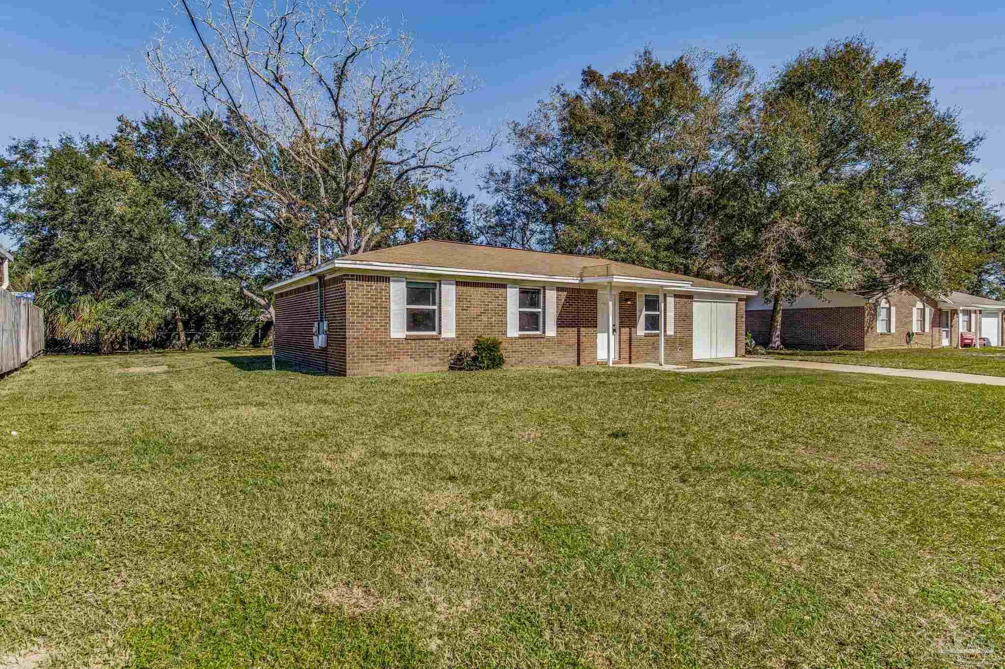 5254 Jenny Circle Pace, FL 32571 - Photo 2 of 44 a front view of a house with a garden