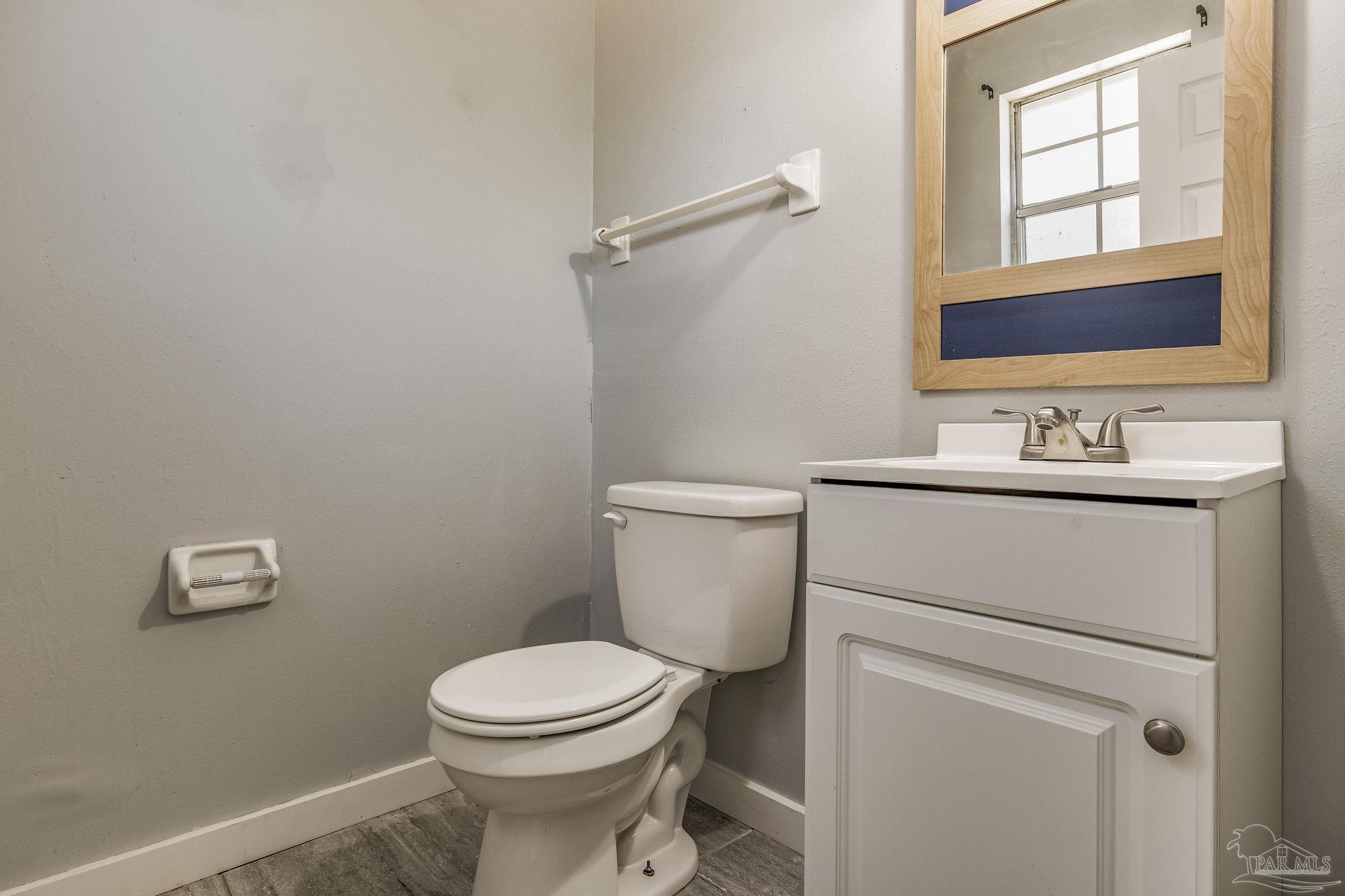 5254 Jenny Circle Pace, FL 32571 - Photo 23 of 44 a bathroom with a toilet sink and mirror