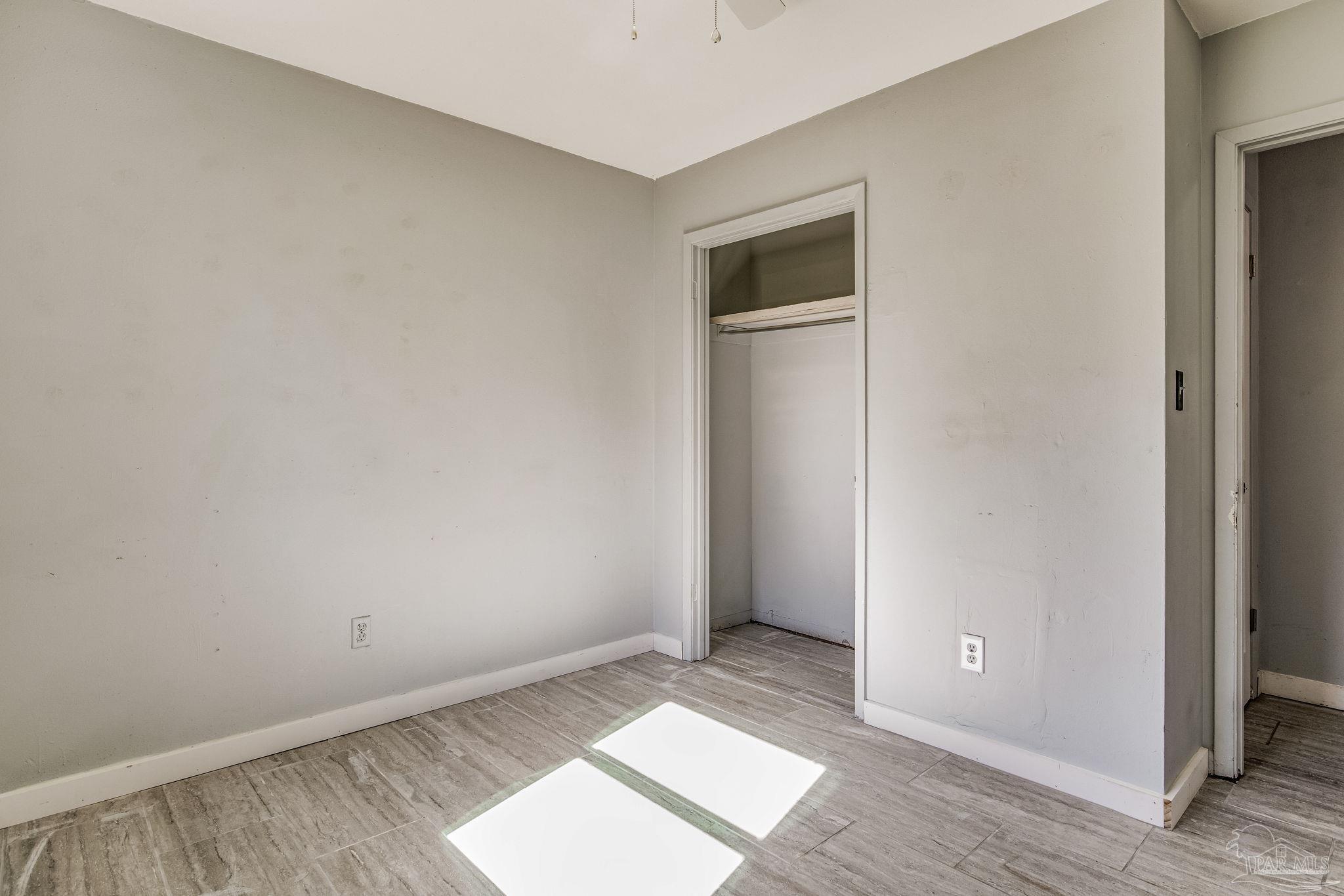 5254 Jenny Circle Pace, FL 32571 - Photo 28 of 44 an empty room with wooden floor and windows