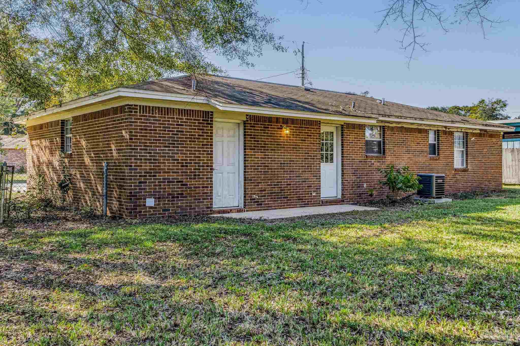 5254 Jenny Circle Pace, FL 32571 - Photo 35 of 44 a front view of a house with a garden