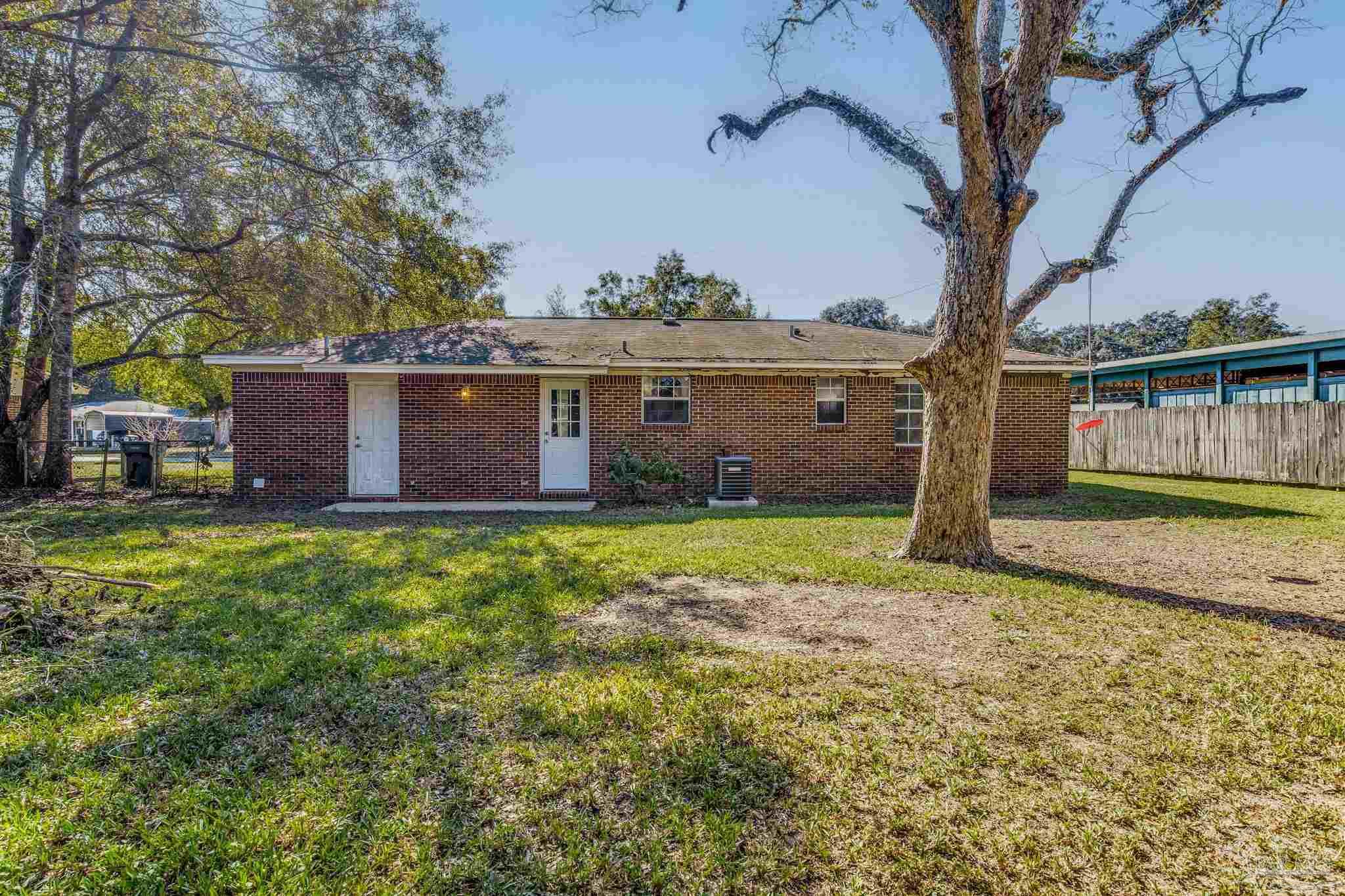 5254 Jenny Circle Pace, FL 32571 - Photo 36 of 44 a view of a house with a yard