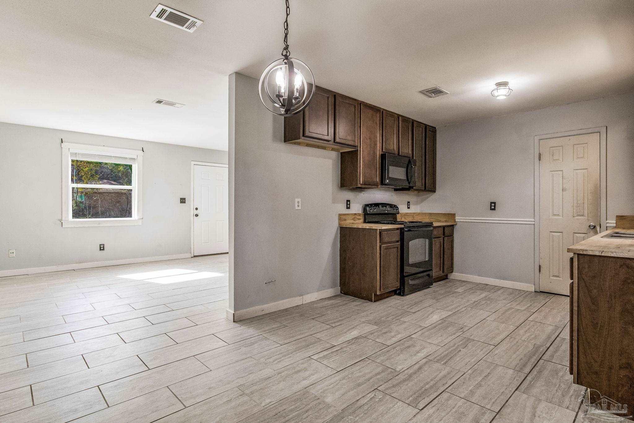 5254 Jenny Circle Pace, FL 32571 - Photo 8 of 44 a kitchen with stainless steel appliances granite countertop a stove a sink and a refrigerator